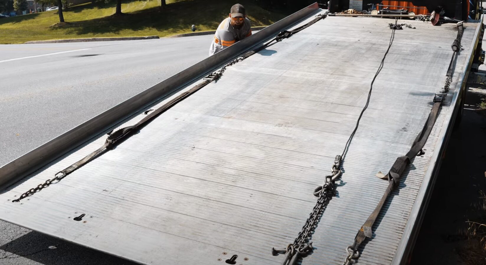 Professional flatbed tow truck with chains and equipment ready for emergency towing service