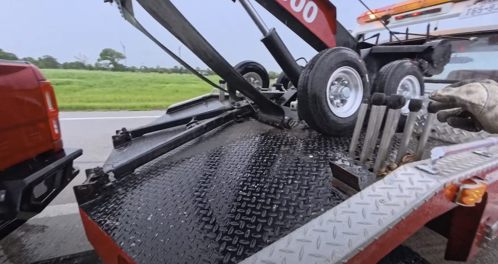 Professional tow truck with hydraulic flatbed system for safe vehicle loading