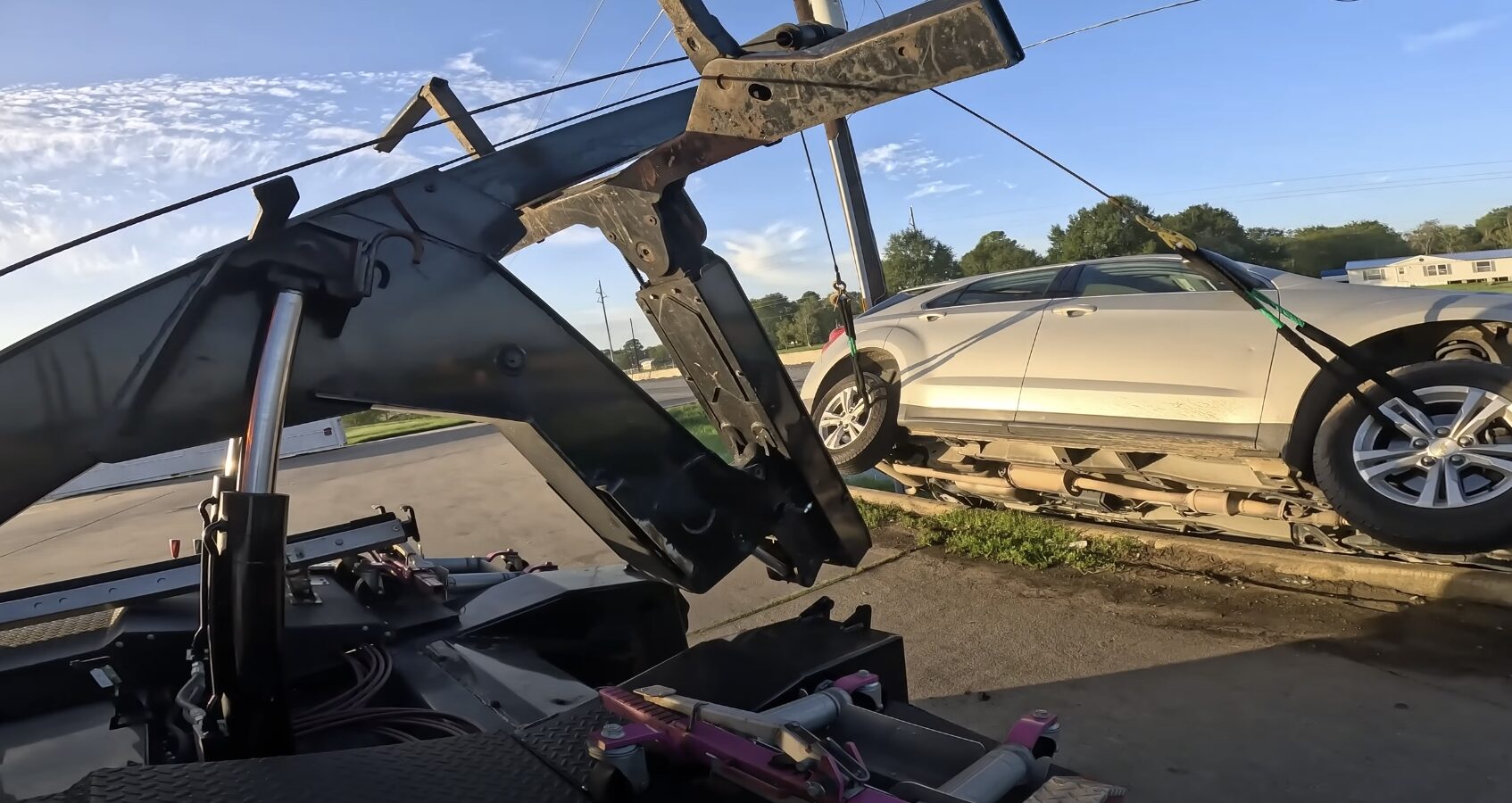 Close-up view of flatbed tow truck loading system and towing equipment